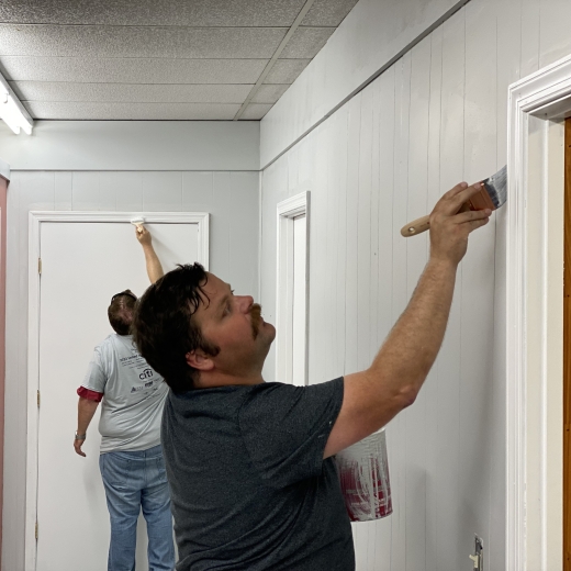 Volunteers painting door trim