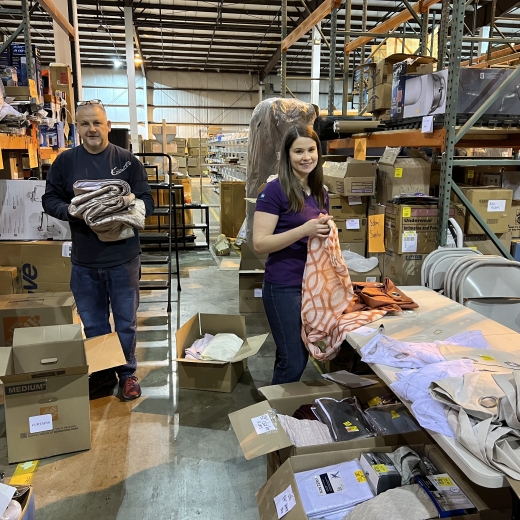 Volunteers sorting items in a warehouse