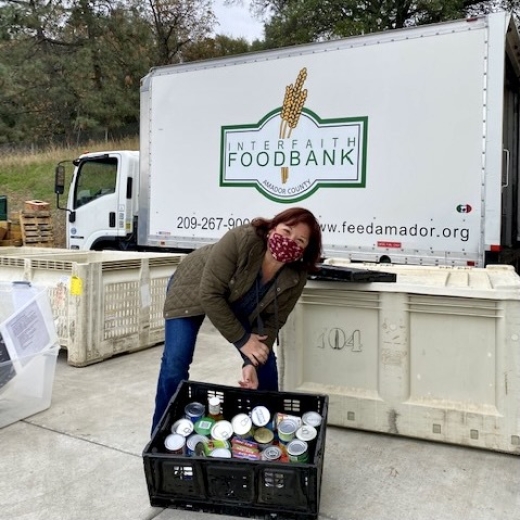 Volunteer collecting food cans